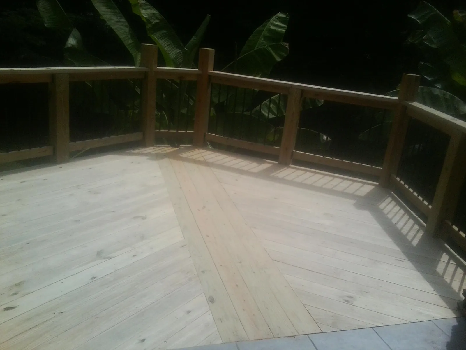 New wood deck and railing built off the back of a home in Lyndhurst